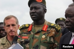 FILE - Brigadier General Lul Ruai Koang of the Sudan People's Liberation Army (SPLA) addresses the media on the killing of U.S. journalist Christopher Allen, at the morgue of the military hospital, in Juba, Aug. 29, 2017.