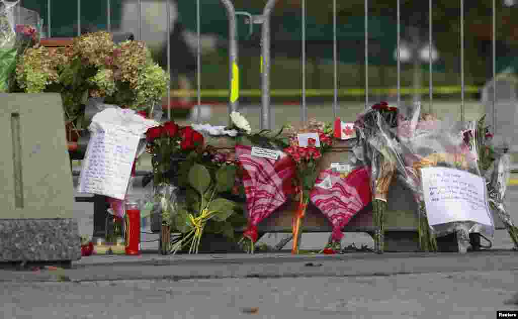Flowers, momentos and well wishes are placed at the National War Memorial in downtown Ottawa, Oct. 23, 2014. 