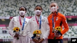 Gold medalist Sydney McLaughlin, of the U.S., center, stands with silver medalist Dalilah Muhammad, of the U.S, left, and bronze medalist Femke Bol, of the Netherlands, during the medal ceremony for the women's 400-meter hurdles, Aug. 4, 2021, in Tokyo.