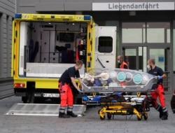 An empty stretcher is moved back into an ambulance which is believed to have transported Alexei Navalny to the Charité Clinic for treatment, in Berlin, Germany, Aug.22, 2020.