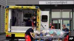 An empty stretcher is moved back into an ambulance which is believed to have transported Alexei Navalny to the Charité Clinic for treatment, in Berlin, Germany, Aug. 22, 2020.