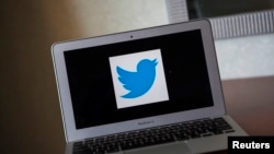 FILE - The Twitter logo is seen on a laptop computer.