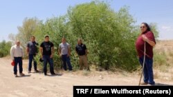 Cacique Jose Sierra, leader of the Ysleta del Sur Pueblo, right, and governing members of the American Indian tribe visit the dried-up bed of the Rio Grande in El Paso, Texas, May 21, 2018. 