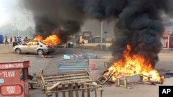 FILE —Anti-government demonstrators set a barricade on fire during clashes in N'Djamena, Chad, October 20, 2022. Security forces opened fire on demonstrators in the country's two largest cities killing at least 60 people, the government spokesman and a morgue official said.