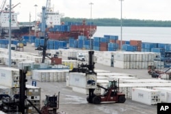 Dockworkers instrumentality    to enactment    astatine  Port Miami, Oct. 4, 2024, successful  Miami, aft  the national   representing 45,000 striking U.S. dockworkers reached a woody  to suspend a three-day onslaught   until Jan. 15 to supply  clip  to negociate  a caller   contract.