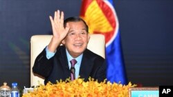 FILE - In this photo provided by the An Khoun Sam Aun/National Television of Cambodia, Cambodian Prime Minister Hun Sen gestures as he joins an online meeting of the ASEAN-China special summit at Peace Palace in Phnom Penh, Cambodia on Nov. 22, 2021. 