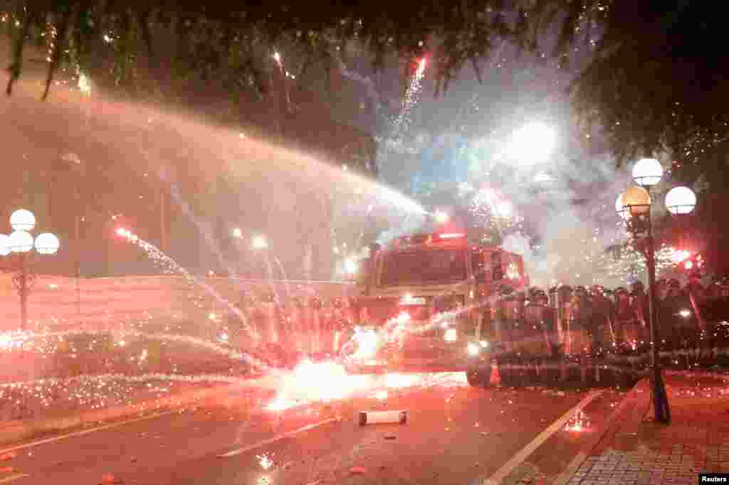 Anti-government supporters throw flares toward police during a protest in Tirana, Albania, June 2, 2019.