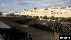 Cambodia's armed forces display anti-riot gear and assault rifles at the Olympic stadium ahead of a general election this weekend, in Phnom Penh, Cambodia, July 25, 2018.