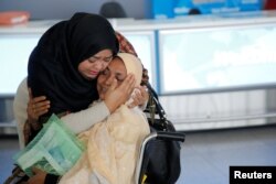 A woman greets her mother after she arrived from Dubai on Emirates Flight 203 at John F. Kennedy International Airport in Queens, New York, Jan. 28, 2017.