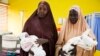 Hajia Muhammed’s relatives carry her healthy twin boys. She delivered with a C-section because one of the twins was in a breeched position in Kaduna, Nigeria. (Photo: Chika Oduah for VOA) 