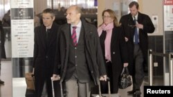 Herman Nackaerts (C) and members of a delegation of the International Atomic Energy Agency (IAEA) check-in before their departure to Iran, at the airport in Vienna, Austria, January 15, 2013. 