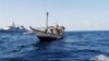 A handout picture received from The Netherlands Ministry of Defence shows a boat containing alleged Somali pirates being apprehended by Netherlands warship Evertsen acting as part of EU counter piracy operations at sea some 150 nautical miles off the coas