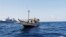 FILE - A handout picture received from The Netherlands Ministry of Defence shows a boat containing alleged Somali pirates being apprehended by Netherlands warship Evertsen.