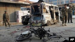 Afghan security personnel stand guard at the site of suicide bomber attack in the city of Jalalabad, east of Kabul, Dec. 3, 2017. 