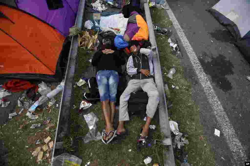 Migrants rest at a makeshift camp at the Horgos border crossing in Serbia, into Hungary. Small groups of migrants continued to sneak into Hungary, a day after the country sealed its border with Serbia and began arresting people trying to breach the razor-wire barrier, while a first group arrived in Croatia seeking another way into the European Union.