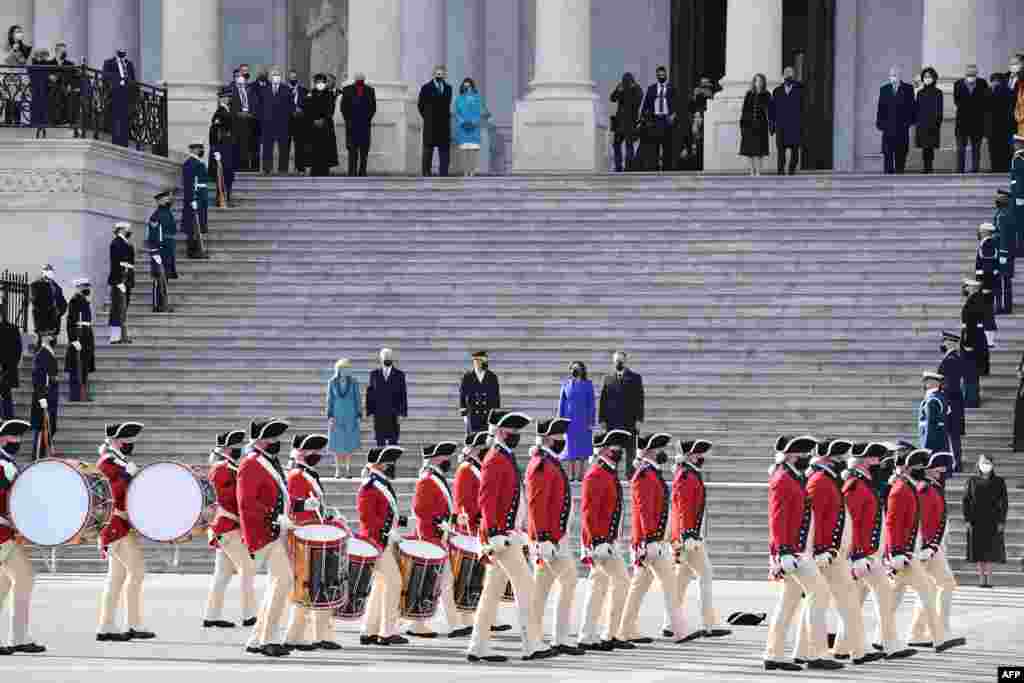 First Lady Jill Biden, President Joe Biden, Vice President Kamala Harris and Second Gentleman Doug Emhoff watch as troops march in front of the Capitol in Washington, DC.