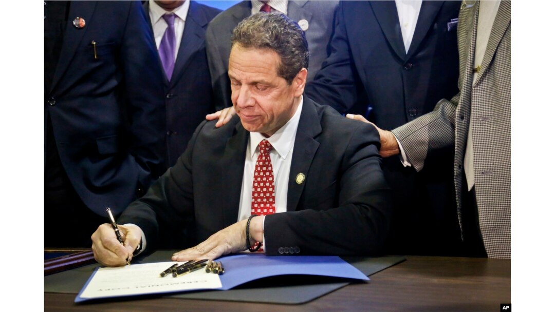 New York Gov. Andrew Cuomo signs new legislation during a signing ceremony in New York, April 10, 2017.