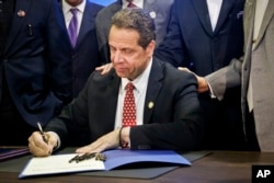 New York Gov. Andrew Cuomo signs new legislation during a signing ceremony in New York, April 10, 2017.