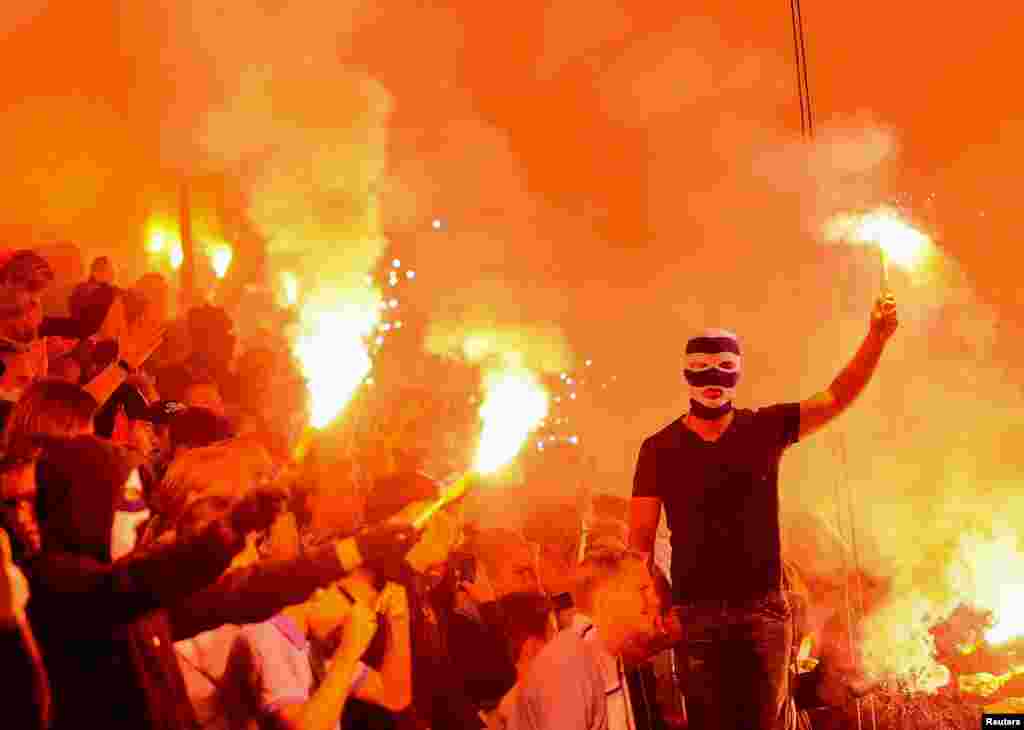 Malmo supporters hold flares as they celebrate after winning their Champions League playoff second leg soccer match against Salzburg in Malmo, Sweden, Aug. 27, 2014.