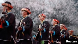 Tibetans play their traditional musical instruments to commemorate Serf Liberation Day in Nyingchi Prefecture, Tibet Autonomous Region, March 27, 2014.