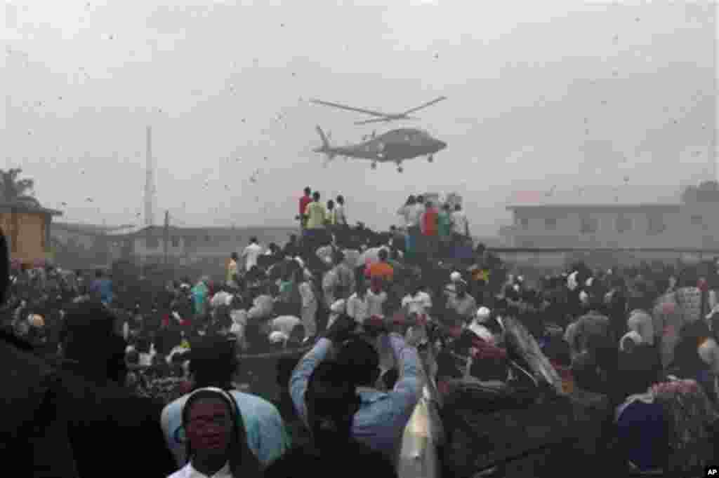 A helicopter flies over the site of a Dana Airlines plane crash in Lagos, Nigeria, Sunday, June 3, 2012.