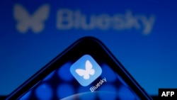 Logo platform media sosial Bluesky ditampilkan di telepon seluler dan tablet, di Paris, 12 November 2024. Jejaring sosial Bluesky melonjak ke salah satu posisi teratas dalam unduhan jejaring sosial dalam seminggu terakhir sejak pemilihan umum Amerika S. (Ian LANGSDON / AFP)