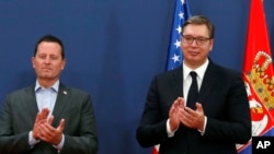 Trump's envoy for Serbia-Kosovo talks Richard Grenell, left, and Serbian President Aleksandar Vucic applaud during a press conference after talks at the Serbia Palace in Belgrade. (File)