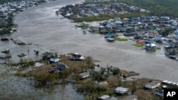 A flooded city is seen in the aftermath of Hurricane Ida, Monday, Aug. 30, 2021, in Lafitte, Louisiana, USA (AP Photo/David J. Phillip)