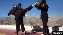 Buddhist nuns help a participant learn Kung Fu, a form of martial art, during a five-day workshop in Hemis region in Ladakh, India, August 17, 2017.