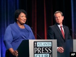 Democratic gubernatorial candidate for Georgia Stacey Abrams, left, speaks as her Republican opponent Secretary of State Brian Kemp looks on during a debate in Atlanta, Oct. 23, 2018.