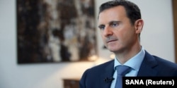 FILE - Syria's President Bashar al-Assad speaks during an interview with the Iranian Khabar TV channel in this handout photograph released by Syria's national news agency SANA, Oct. 4, 2015.