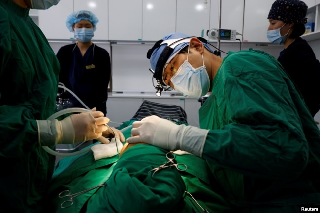 FILE PHOTO Park Cheol-woo a director of WooAhIn Plastic Surgery Clinic conducts a nose plastic surgery of Ryu Han-na, amid the coronavirus disease (COVID-19) pandemic in Seoul, South Korea, December 17, 2020. Picture taken on December 17, 2020. REUTERS/Kim Hong-Ji