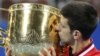 Novak Djokovic of Serbia kisses his trophy after winning the men&#39;s singles final match against Rafael Nadal of Spain at the China Open Tennis Tournament in Beijing, China.