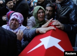 Relatives of Fatih Cakmak, a security guard and a victim of an attack by a gunman at Reina nightclub, react during his funeral in Istanbul, Turkey, Jan. 2, 2017.