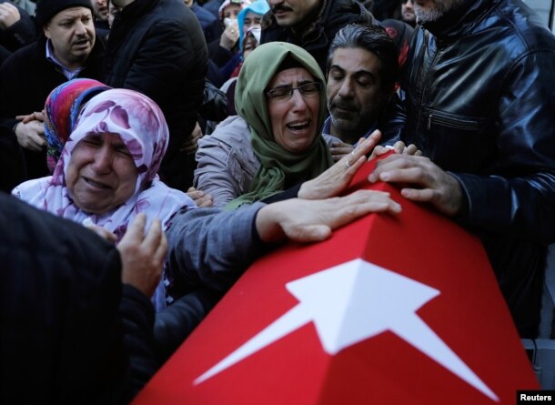 FILE - Relatives of Fatih Cakmak, a security guard and a victim of an attack by a gunman at Reina nightclub, react during his funeral in Istanbul, Turkey, Jan. 2, 2017.