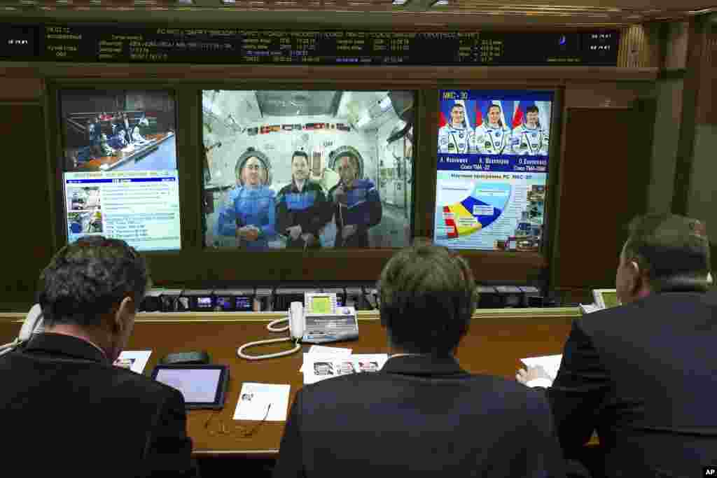 Russian cosmonauts Anatoly Ivanishin (L), Oleg Kononenko (C) and Anton Shkaplerov onboard the International Space Station communicate their votes at mission control centre in Korolyov, outside Moscow, March 4, 2012. (Reuters) 