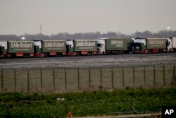 Some 150 trucks leave Manston Airfield during a 'no-deal' Brexit test for where 6,000 trucks could be parked at the former airfield near Ramsgate in south east England, Monday, Jan. 7, 2019.