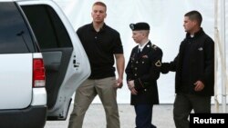 U.S. Army Private First Class Bradley Manning (C) is escorted out after a day of testimony at his court martial trial at Fort Meade, Maryland, July 8, 2013.