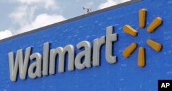 FILE - A Walmart sign is shown at a store in Hialeah Gardens, Fla., June 1, 2017.