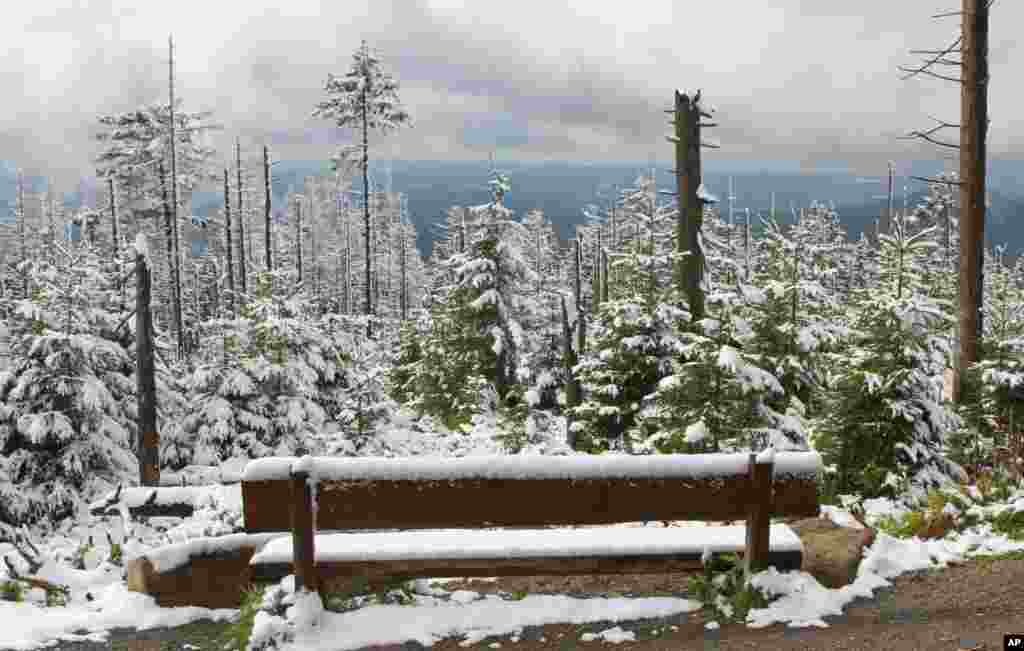 Snow covers a bench on Brocken, in the Harz mountains near Schierke, Germany.