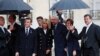 Belgian Prime Minister Charles Michel, center, and his partner Amelie Derbaudrenghien, second right, are greeted by French President Emmanuel Macron, left, and his wife Brigitte Macron as they arrive at the Elysee Palace in Paris to participate in a World