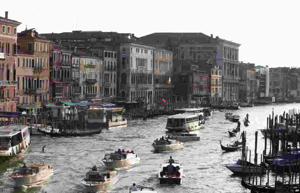 Boats sail past the Cavalli Palace, center left, as seen from the Rialto bridge in Venice, Italy. Venice city officials are closing a walkway fronting the picturesque Grand Canal on Sept. 29 to keep crowds away from George Clooney's wedding to human rights lawyer Amal Alamuddin. 