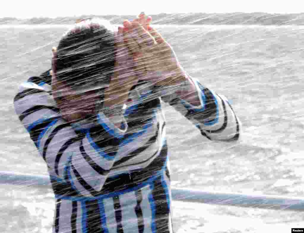 Sweden&#39;s Crown Princess Victoria covers herself from the water onboard of the Estonian Navy ship Wambola near Tallinn, Estonia.