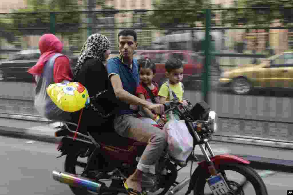 An Egyptian family celebrates the first day of the Eid al-Fitr holiday, in Cairo, Egypt, July 28, 2014.