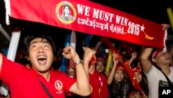 Supporters of Myanmar's National League for Democracy party cheer as election results are posted outside the NLD headquarters in Yangon, Myanmar, Nov. 9, 2015. 