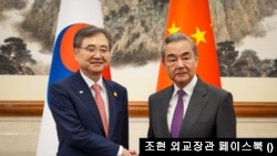 지난해 9월 조현 한국 외교부 장관(사진 왼쪽)이 왕이 중국 외교부장과 중국 베이징에서 만나 악수하는 모습 (자료사진)