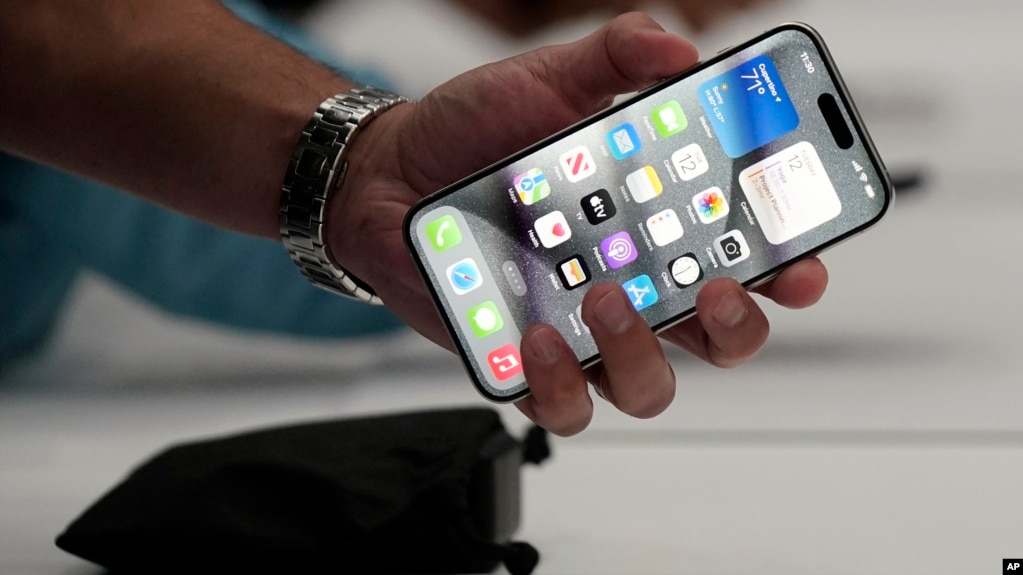 In this file photo, a person holds an iPhone 15 Pro at the Apple campus, Sept. 12, 2023, in Cupertino, Calif. (AP Photo/Jeff Chiu, File)