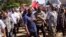 Democratic Republic of Congo's President Joseph Kabila (front C) walks along a street in Bunagana, a town formerly held by M23 rebels, in eastern Democratic Republic of the Congo, Nov. 30, 2013.