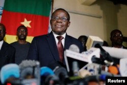 FILE - Maurice Kamto, then-presidential candidate of Renaissance Movement (MRC), holds a news conference at his headquarter in Yaounde, Cameroon, Oct. 8, 2018.