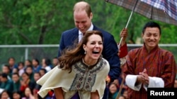 Istri Pangeran William, Duchess of Cambridge, melepaskan panah dalam perlombaan di Thimphu, Bhutan (14/4). (Reuters/Cathal McNaughton)